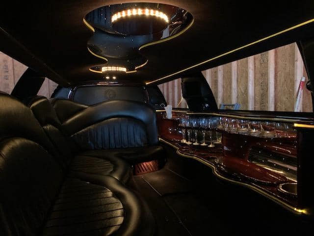 Lincoln limousine interior with leather seating and bar
